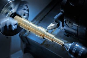 CNC machine performing precision turning on a metal workpiece with advanced programming.