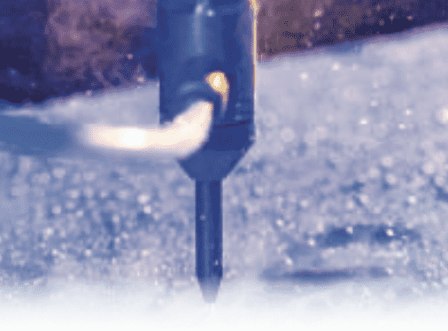 Close-up of CNC water jet cutting through composite sheet with precision and high-pressure stream
