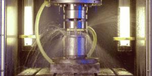 Electrochemical milling machine spraying electrolyte during precision metal shaping in an industrial CNC process