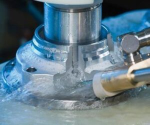 electrochemical milling tool shaping a metal component with electrolyte flow for high-precision industrial machining