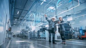 Engineers reviewing AI-generated CNC production data in a smart factory with digital overlays & advanced automation systems.