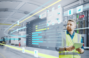 Engineer using tablet to monitor CNC processes with cloud-based software and digital dashboards.