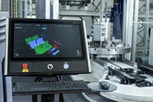 CNC machine with smart factory interface screen displaying automated production monitoring.